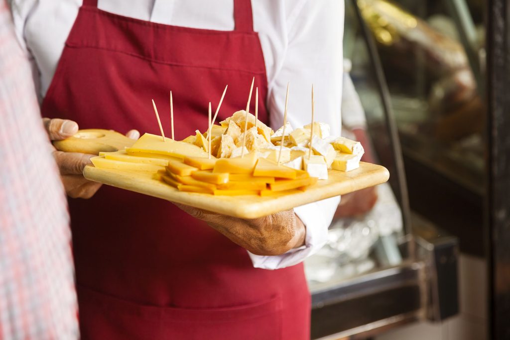 Person holding a cheese sampler