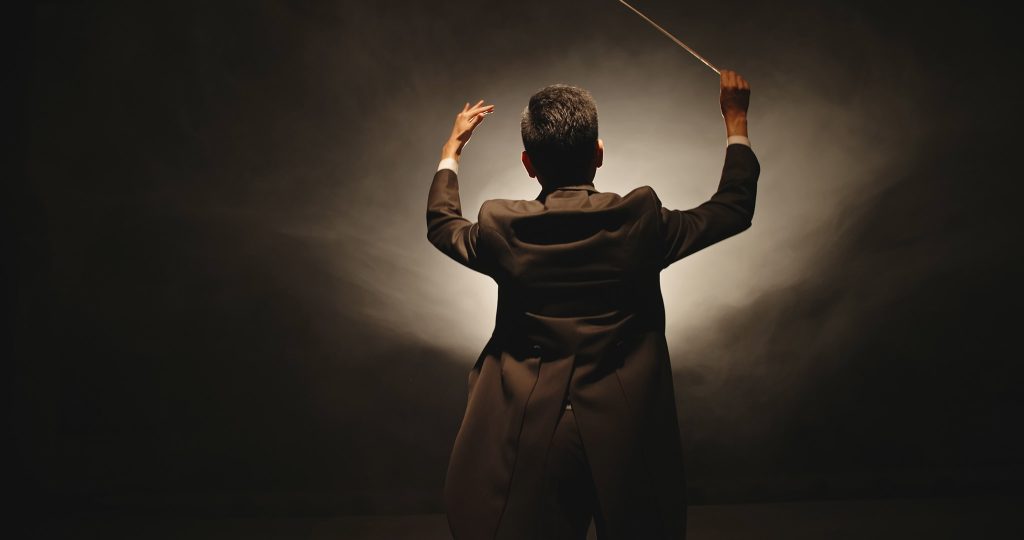 symphony conductor holding a baton